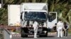 Investigators continue to work at the scene near the heavy truck that ran into a crowd at high speed killing scores who were celebrating the Bastille Day, July 14 national holiday on the Promenade des Anglais in Nice, France, July 15, 2016. 