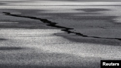 A road is damaged in the village of Grindavik, which was evacuated due to volcanic activity, in Iceland, Nov. 14, 2023. 