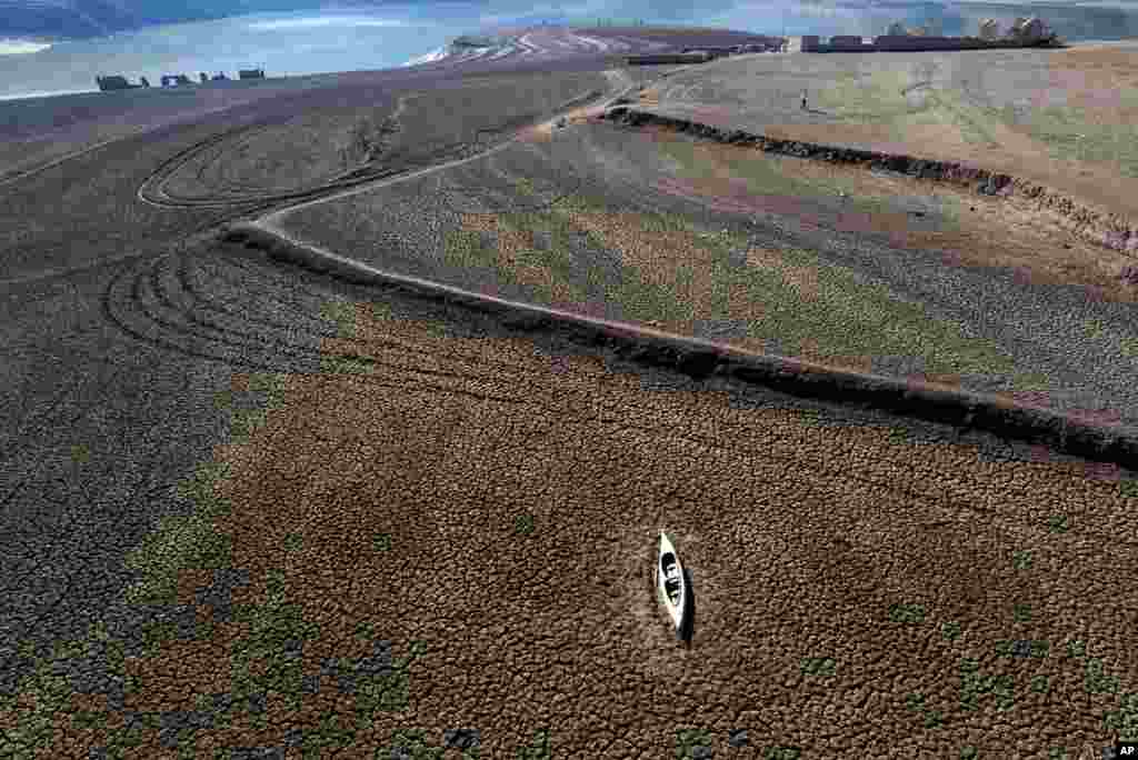 An abandoned canoe lies on the cracked ground at the Sau reservoir, which is only at 5 percent of its capacity, in Vilanova de Sau, about 100 km (62 miles) north of Barcelona, Spain. Barcelona and the surrounding area of Spain's northeast Catalonia are preparing to face tighter water restrictions amid a historic drought that has shrunk reservoirs to record lows. 