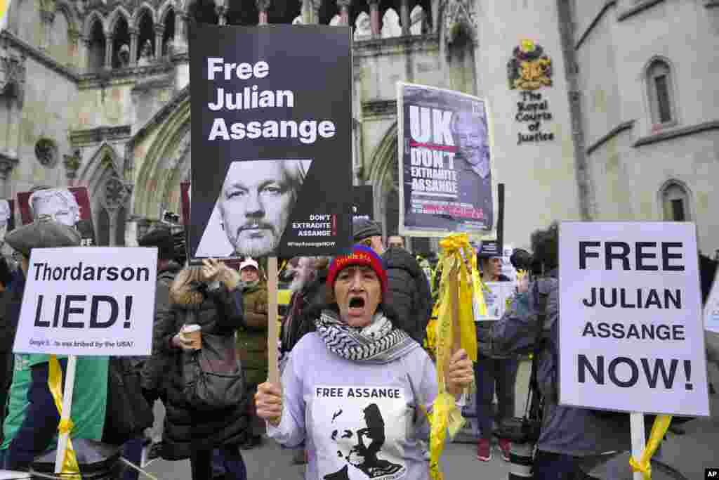 Demonstrators hold banners outside the Royal Courts of Justice in London. WikiLeaks founder Julian Assange will make his final appeal against his impending extradition to the United States at the court. 