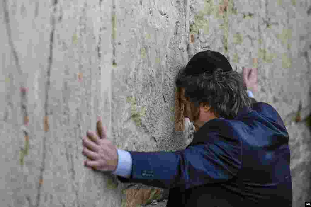 Argentine President Javier Milei touches the Western Wall, the holiest site where Jews can pray, in Jerusalem's Old City.