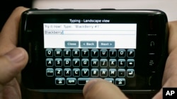 In this Nov. 21, 2008 file photo, a person types on a portable device using his thumbs in Mountain View, Calif., Friday, Nov. 21, 2008. (AP Photo/Paul Sakuma, file)