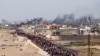 Warga Palestina menunggu truk bantuan menyeberang di tengah Jalur Gaza pada Minggu, 19 Mei 2024. (AP Photo/Abdel Kareem Hana)