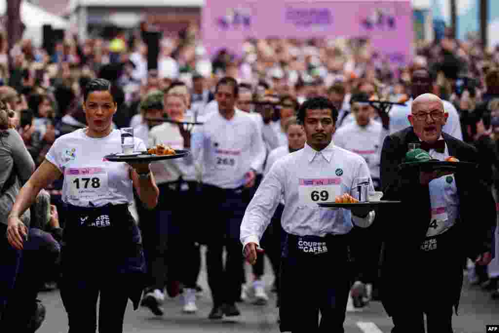 Waiters and waitresses compete in a traditional "Course des cafes" (the cafes' race), in front of the City Hall in central Paris, France.