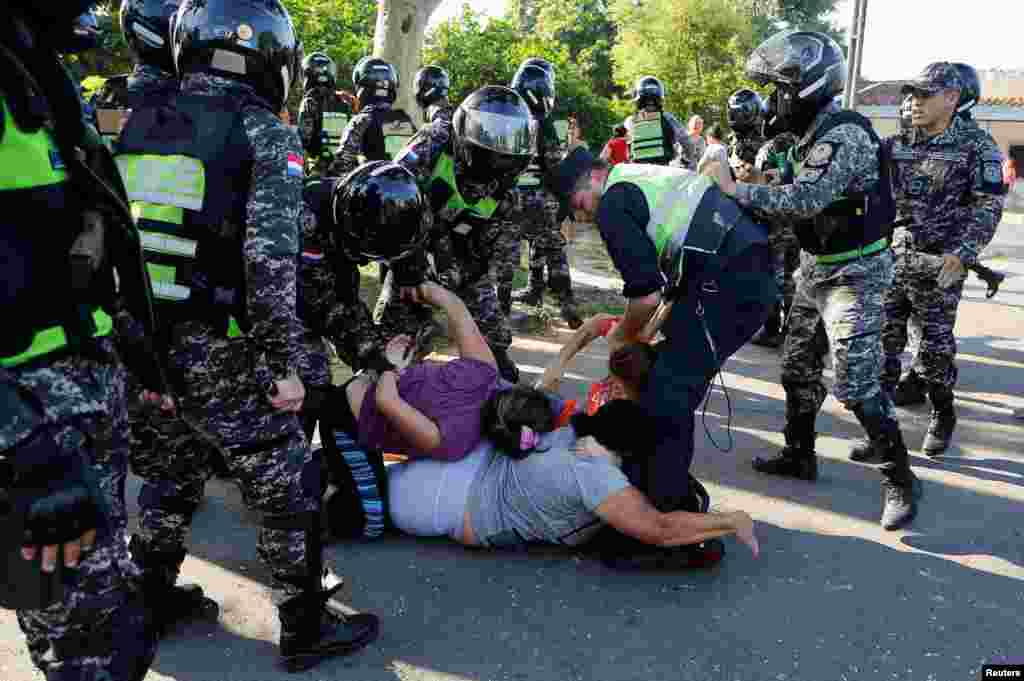 Relatives of inmates clash with police during a security operation after a riot broke out at the Tacumbu penitentiary, in Asuncion, Paraguay.