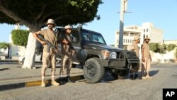 Libyan security forces stand guard in Tripoli on Aug. 16, 2023. Clashes between rival militias in Libya's capital killed at least 45 people and left residents trapped in their homes, unable to escape the violence, medical authorities said.