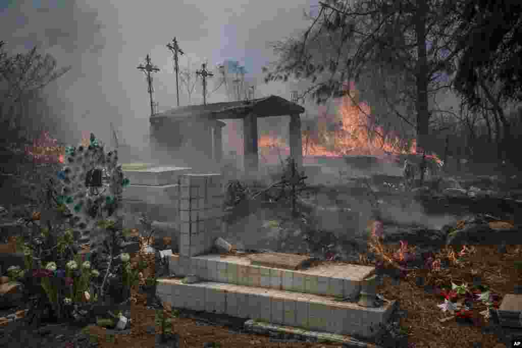 Wildfires burn parts of a cemetery in Nogales, Mexico, March 25, 2024. Emergency crews are working to contain wildfires burning across parts of the High Mountains area in Veracruz state.