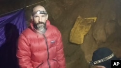 In this screen grab from video, American caver Mark Dickey, 40, talks to camera next to a colleague inside the Morca cave near Anamur, southern Turkey, Sept. 7, 2023.