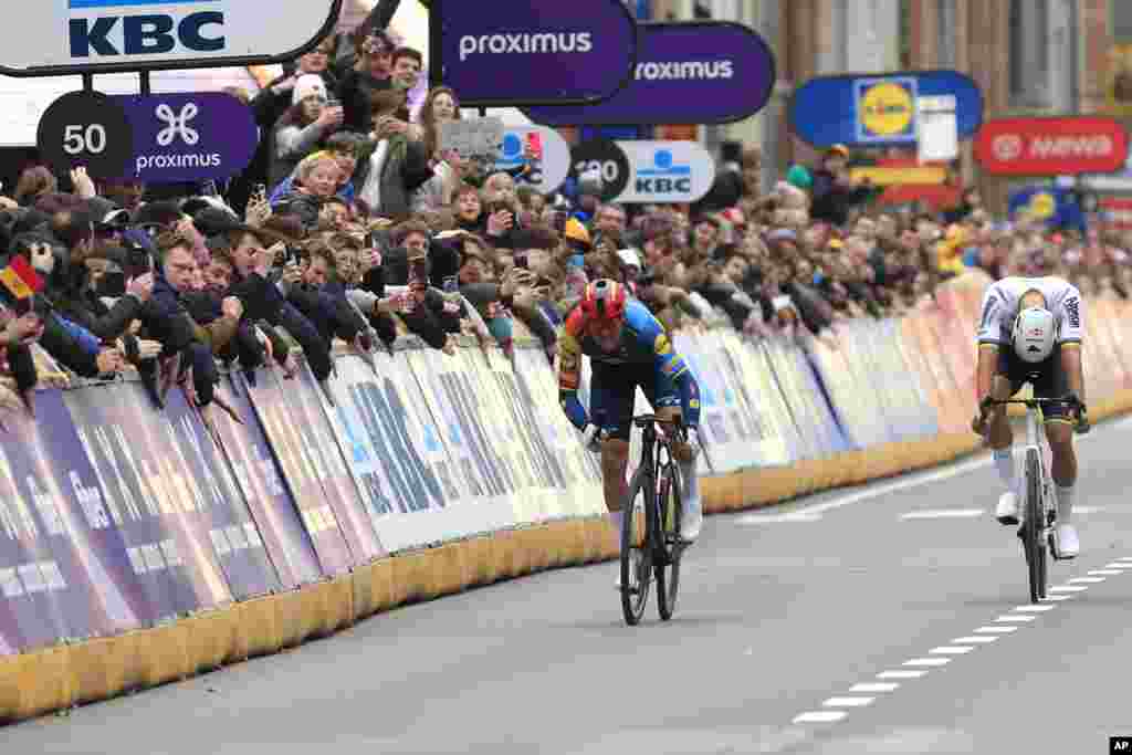 Denmark's Mads Pedersen of the LIDL-Trek team, left, sprints toward the finish line ahead of Netherland's Mathieu Van Der Poel of the Alpecin-Deceuninck team during the Gent Wevelgem cycling race in Wevelgem, Belgium.