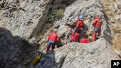 European Cave Rescue Association (ECRA) members work next to the entrance of Morca cave near Anamur, southern Turkey, Sept. 7, 2023.
