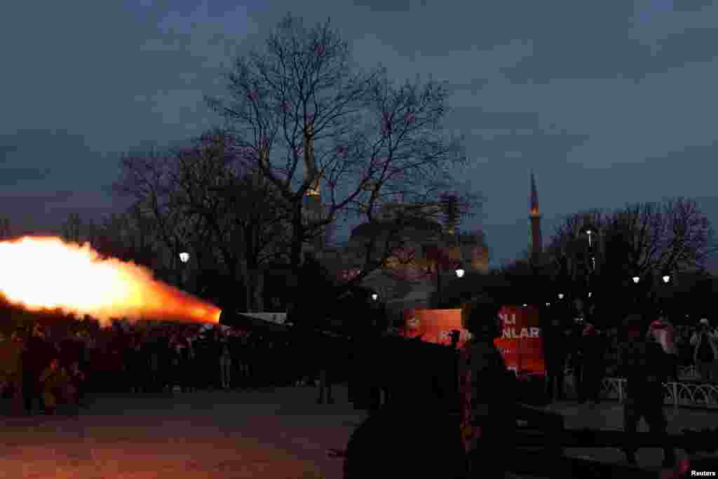 Turkish soldiers fire a cannon to mark the end of fasting during the holy month of Ramadan at Sultanahmet Square in Istanbul.