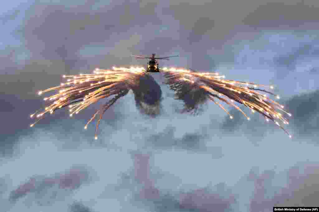 A Merlin helicopter from 820 Naval Air Squadron loaded and fired flares from HMS Prince of Wales, while embarked for NATO Exercise Steadfast Defender at an undisclosed location.