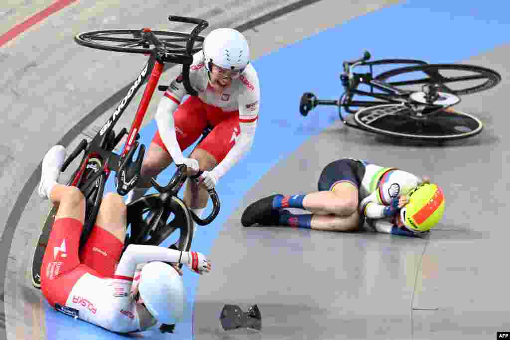 Poland's Daria Pikulik, Poland's Wiktoria Pikulik and Britain's Elinor Barker (R) crash in the Women's Madison race during the fifth day of the UEC European Track Cycling Championships in Apeldoorn, Netherlands.