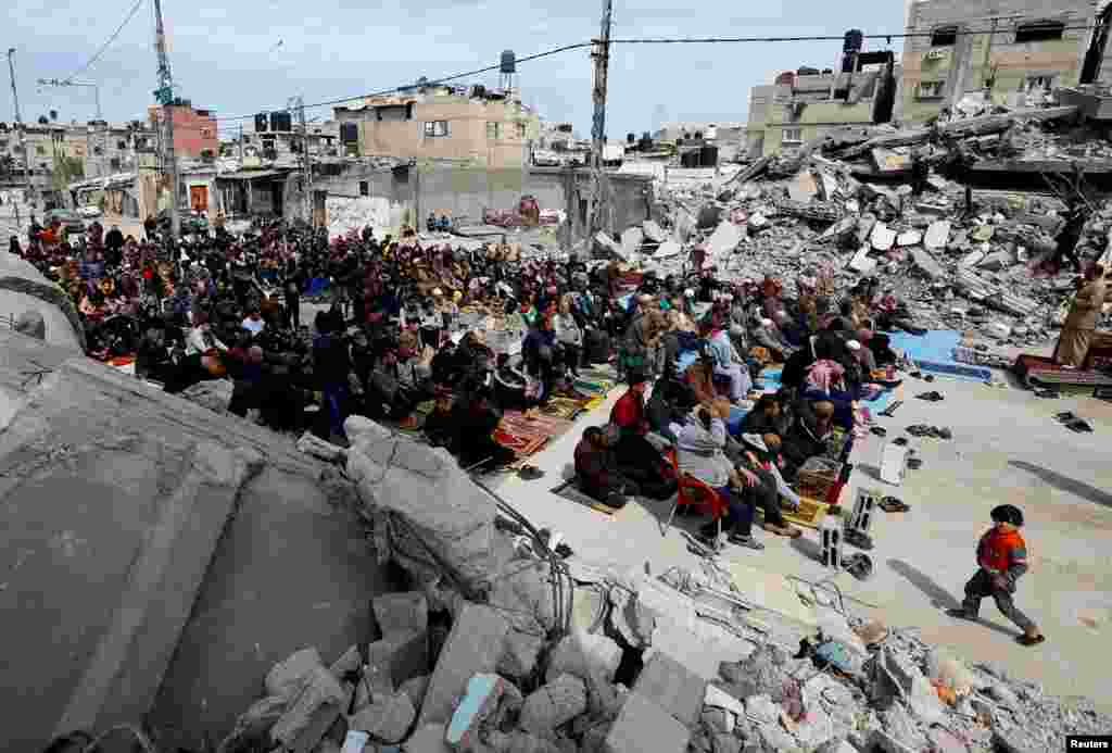 Palestinians attend Friday prayers near the ruins of a mosque destroyed in Israeli strikes, amid the ongoing conflict between Israel and Hamas, in Rafah in the southern Gaza Strip.