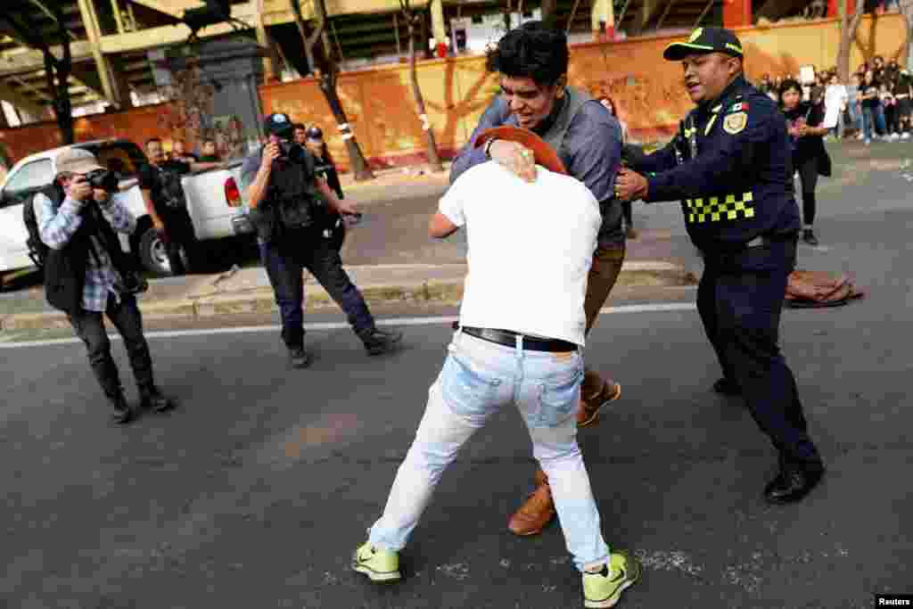 Protesters clash with attendees during a protest against the return of bullfighting, outside the Plaza de Toros Mexico bullfighting ring, in Mexico City, Mexico, Jan. 28, 2024.