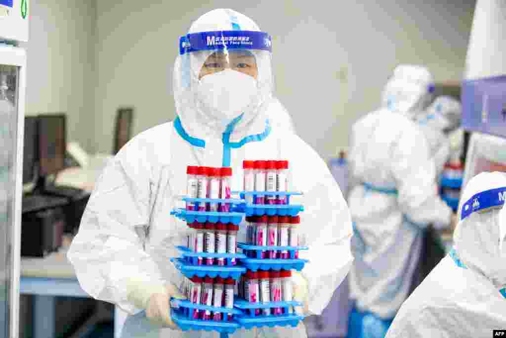 A laboratory technician wearing personal protective equipment (PPE) works at a Covid-19 testing laboratory in Haian in China's eastern Jiangsu province, China.