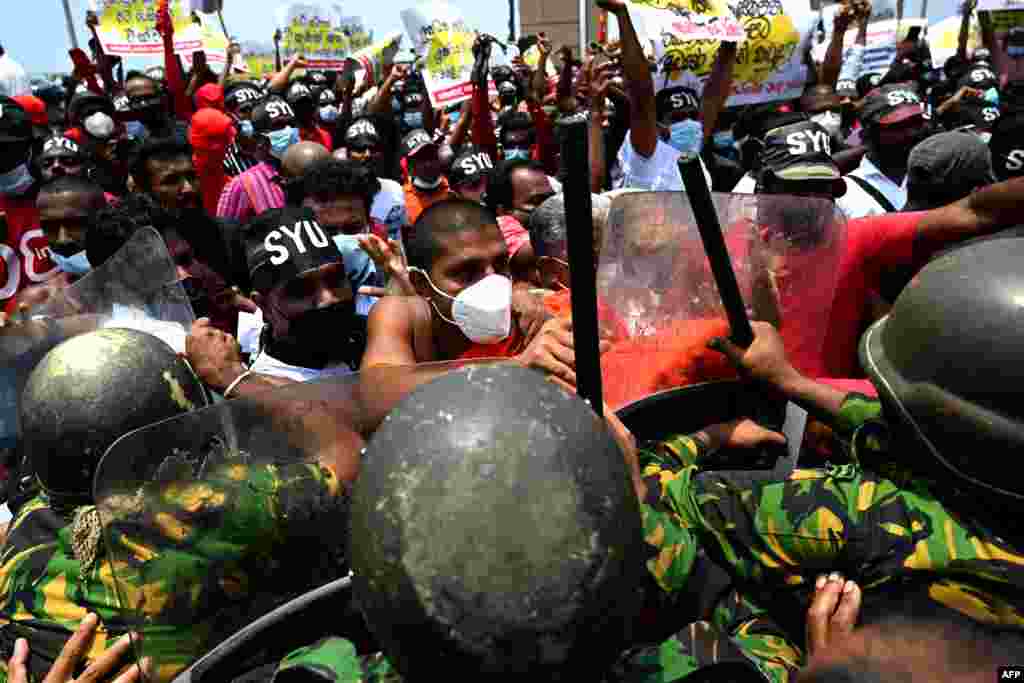 Police Special Task Force officers try to stop demonstrators during a protest against the rising living costs, outside President Gotabaya Rajapaksa's seafront office in Colombo, Sri Lanka.