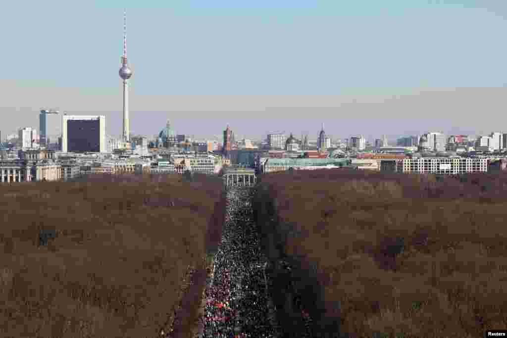 A general view shows the Berlin skyline, Germany, as people march on the Strasse des 17. Juni, near the Brandenburg Gate, during an anti-war demonstration "Stop the War. Peace and Solidarity for the People in Ukraine", to protest against Russia's invasion of Ukraine.