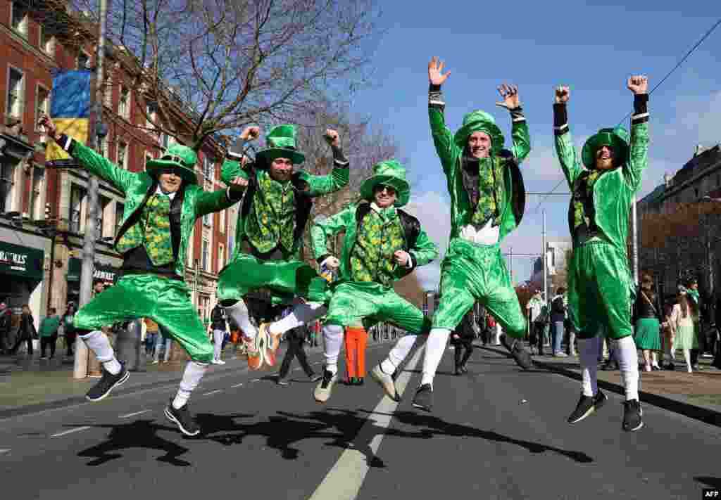 Revelers from Denmark dressed in green pose for a photo during the the annual St. Patrick's Day parade in Dublin, Ireland.