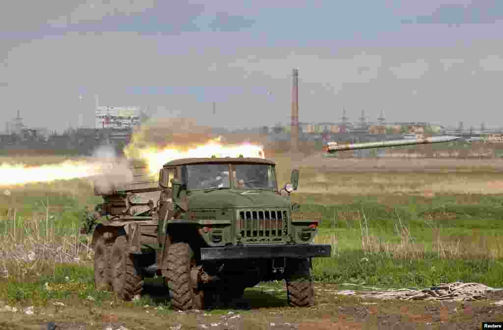 Service members of pro-Russian troops fire a BM-21 Grad multiple rocket launch system during a fighting near Azovstal Iron and Steel Works plant in the southern port city of Mariupol, Ukraine, May 2, 2022.