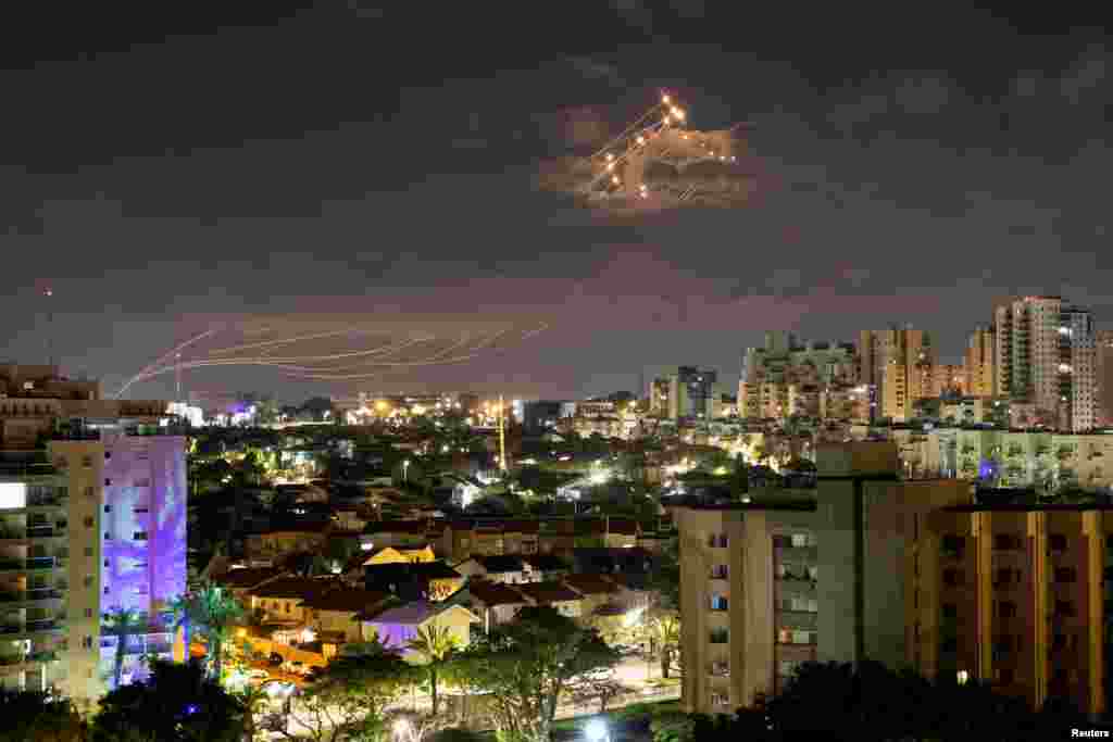 Streaks of light line the sky as Israel's Iron Dome anti-missile system intercepts rockets launched from the Gaza Strip toward Israel, as seen from Ashkelon.