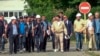 In this handout photo taken from video released by Russian Defense Ministry Press Service, International Atomic Energy Agency Director Rafael Grossi, center in white helmet, and IAEA members walk while inspecting the Zaporizhzhia Nuclear Power Plant in Ukraine, Sept. 1, 2022. 