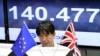 A monitor displays the exchange rate of the Japanese yen against the British Pound as a trader works at a foreign exchange brokerage in Tokyo, Japan, June 24, 2016.