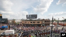FILE - Protesters arrive at Wrigley Field to demand more government action against gun violence, Aug. 2, 2018, in Chicago.