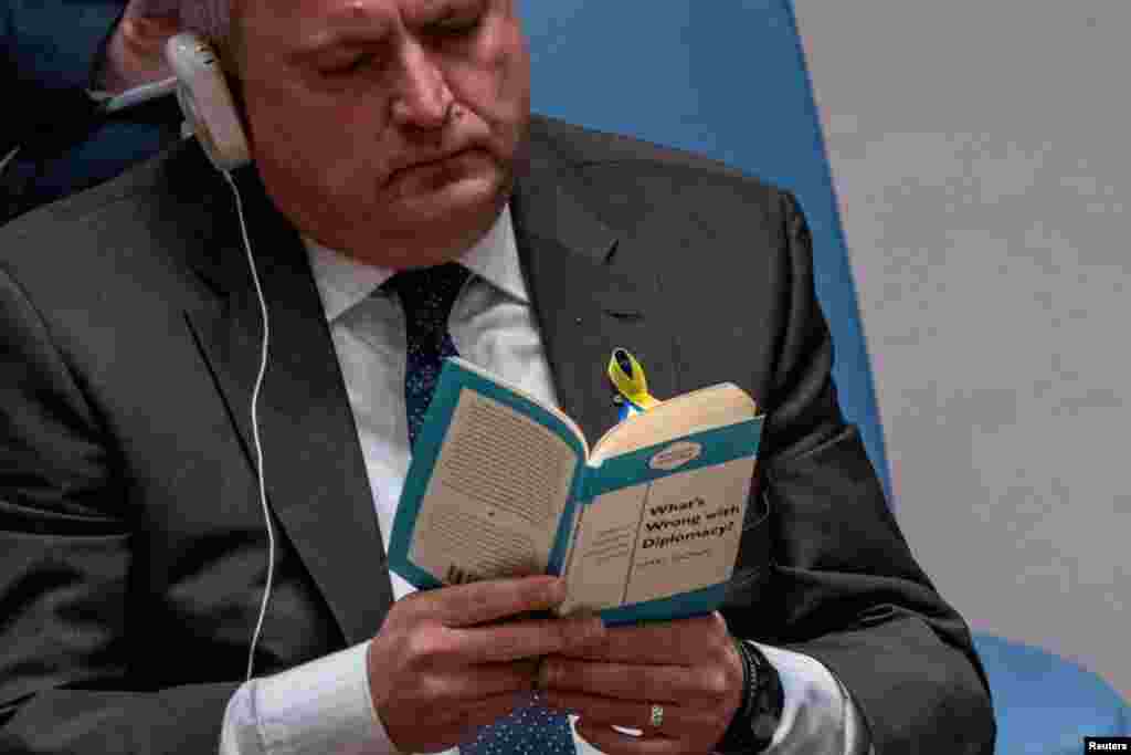Ukrainian Ambassador to the U.N. Sergiy Kyslytsya reads a book titled "What’s Wrong with Diplomacy?" as Russian Ambassador to the U.N. Vasily Nebenzya speaks to the United Nations Security Council, at the United Nations Headquarters in New York, March 29, 2022.