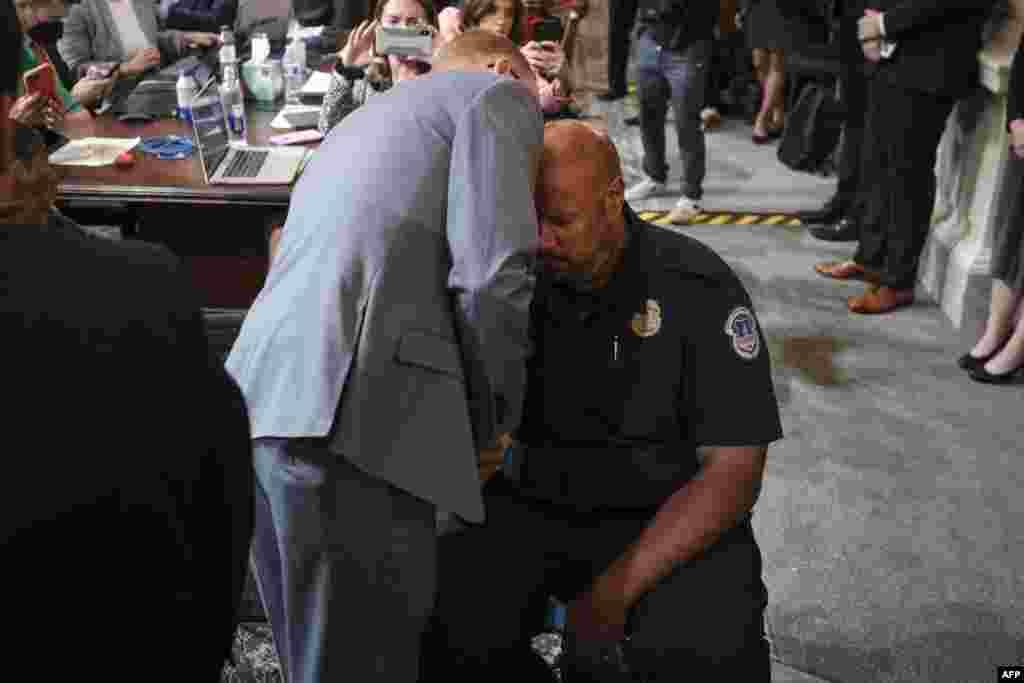 Stephen Ayres (L), who has pleaded guilty to entering the Capitol illegally on January 6, 2021, talks with U.S. Capitol Police Officer Harry Dunn (R) at the conclusion of a full committee hearing on "the January 6 Investigation," on Capitol Hill, July 12, 2022, in Washington.