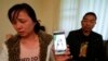Ronggao Zhang and her husband, Ronggao Zhang, display a photo of them with their missing daughter Yingying Zhang, a University of Illinois student, in Urbana, Illinois, Nov. 1, 2017.