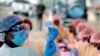 FILE - A health worker fills a syringe with Ebola vaccine before injecting it to a patient, in Goma, Democratic Republic of Congo, Aug. 5, 2019.
