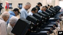 FILE - People cast their ballots in Carson City, Nevada, Nov. 4, 2014. 