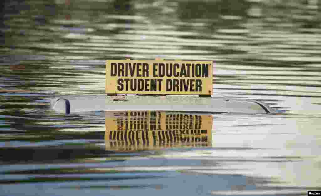 A driver education vehicle is seen submerged in floodwaters following Hurricane Matthew in Lumberton, North Carolina, Oct.10, 2016.