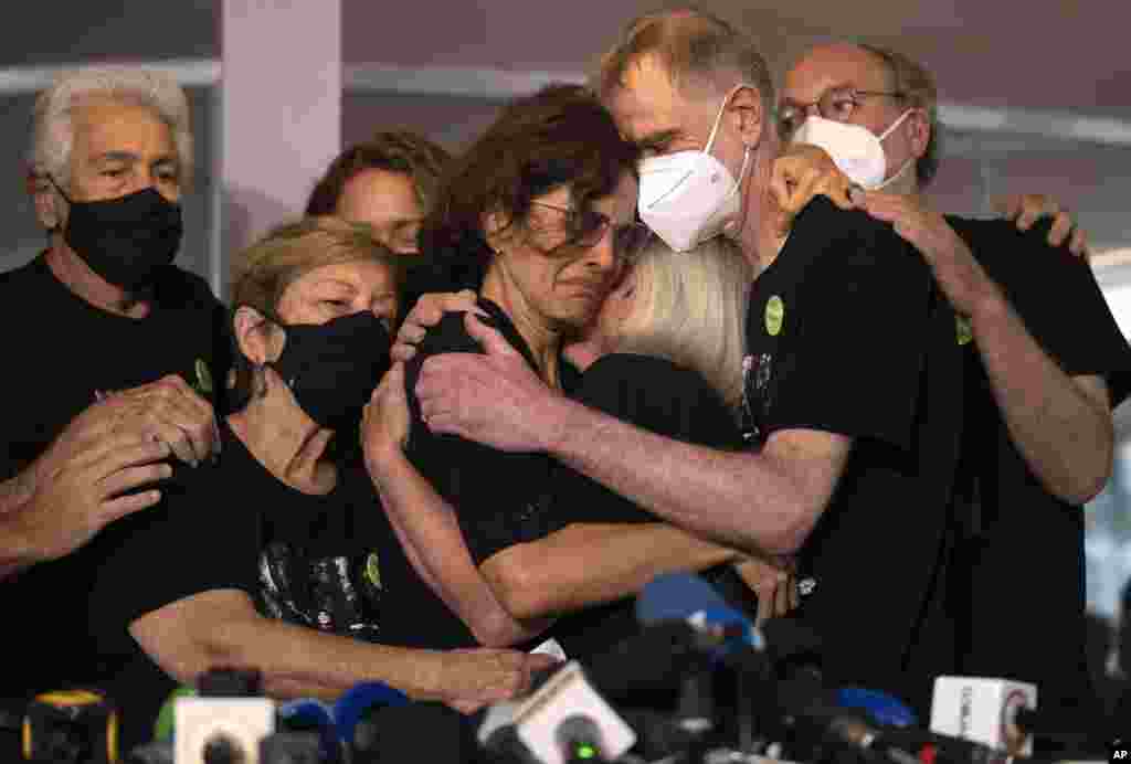 Relatives mourn as Alessandra Sampaio, center, embraces her sister-in-law Sian Phillips after speaking to the media during the funeral of her husband British journalist Dom Phillips at the Parque da Colina cemetery in Niteroi, Brazil. Family and friends paid their final respects to Phillips who was killed in the Amazon region along with the Indigenous expert Bruno Pereira.