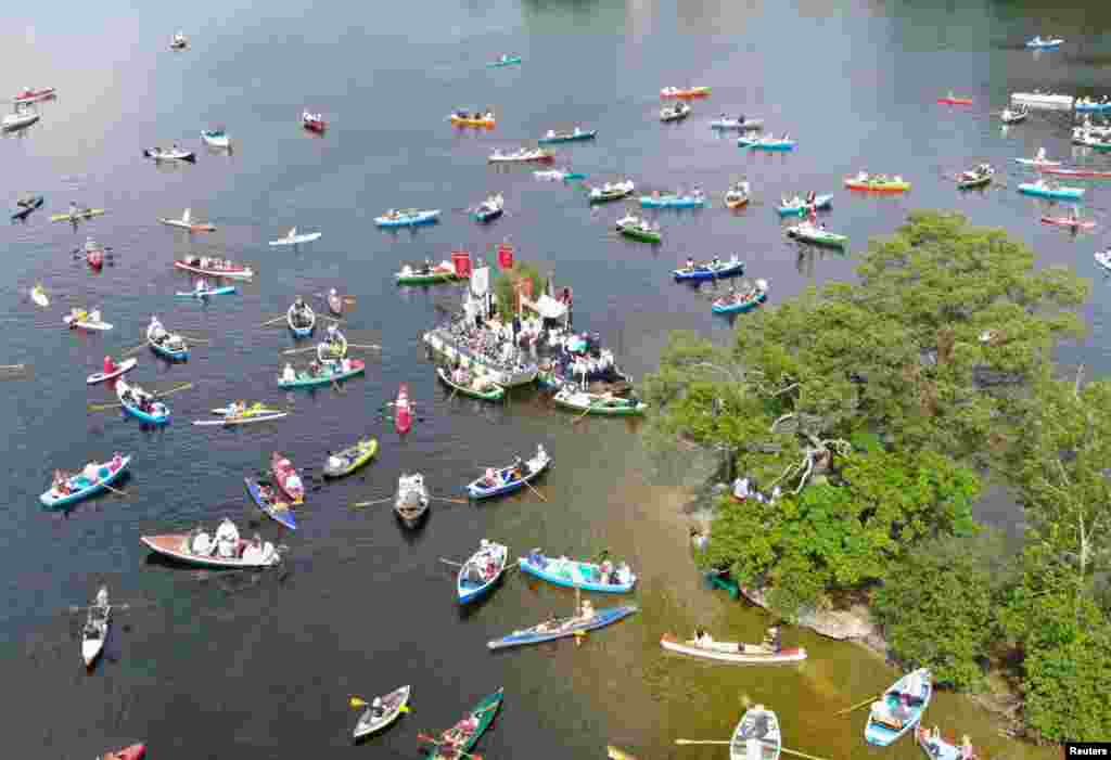 Boats gather for a traditional Bavarian Corpus Christi boat procession on Lake Staffelsee in southern Bavaria, near Murnau, Germany.