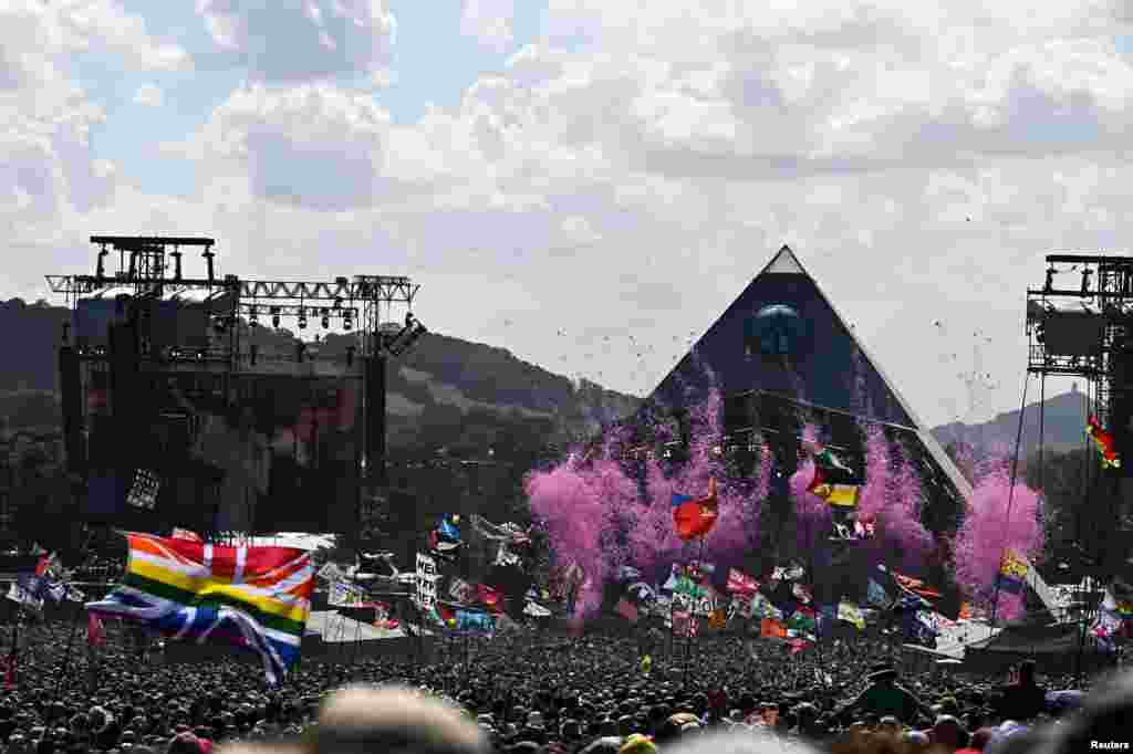 Revelers dance as Diana Ross headlines the Pyramid stage at Worthy Farm in Somerset during the Glastonbury Festival in Britain.