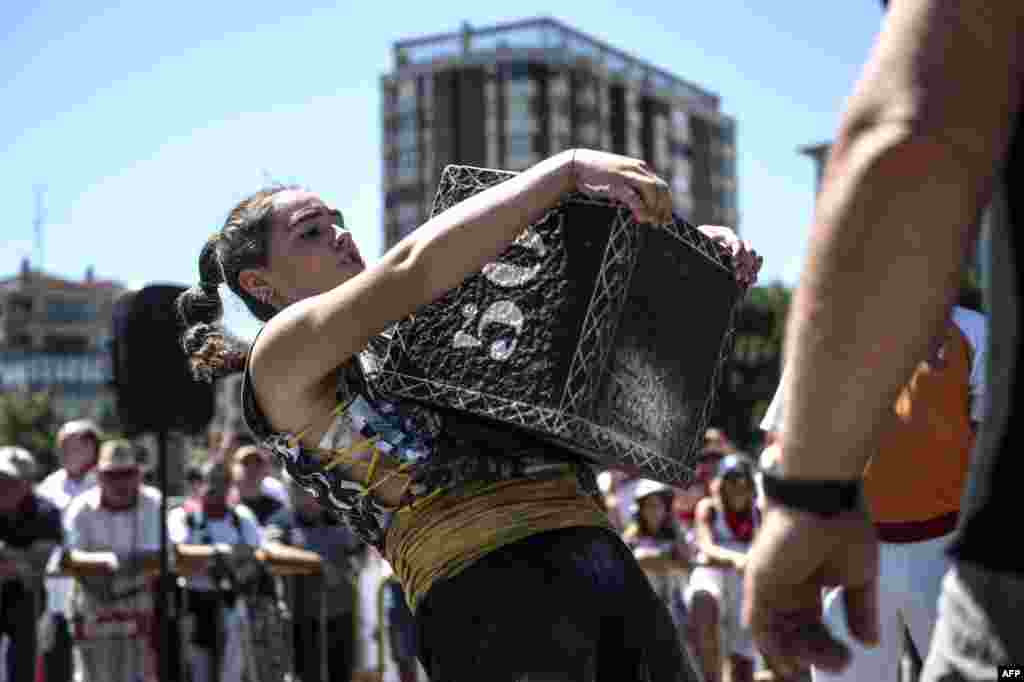 Basque "Harrijasotzaile" stone lifter Udane Ostolaza lifts a stone during the San Fermin Festival in Pamplona, northern Spain.