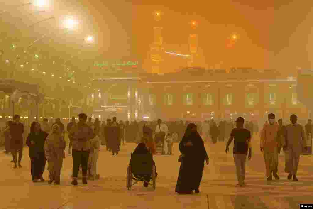 People are seen near Imam Hussein shrine during a sandstorm in the holy city of Kerbala, Iraq.
