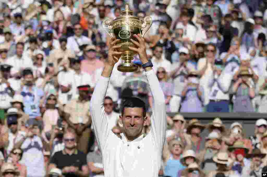 Serbia's Novak Djokovic celebrates beating Australia's Nick Kyrgios in the final of the men's singles on day fourteen of the Wimbledon tennis championships in London.