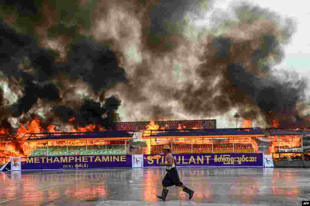 Smoke rises from a burning pile of seized illegal drugs during a destruction ceremony to mark the United Nations' "International Day against Drug Abuse and Illicit Trafficking" in Yangon, Myanmar.