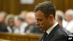 Oscar Pistorius sits in court, after judge Thokozile Masipais sentence Pistorius to five years in prison, in Pretoria, South Africa, Oct. 21, 2014.