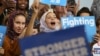 FILE - Young Muslim women listen to Democratic candidate Hillary Clinton speak at a voter registration rally in Detroit, Michigan, Oct. 10, 2016. Out of some 3.3 million Muslims living in America, about 1.5 million are eligible to vote, data shows.