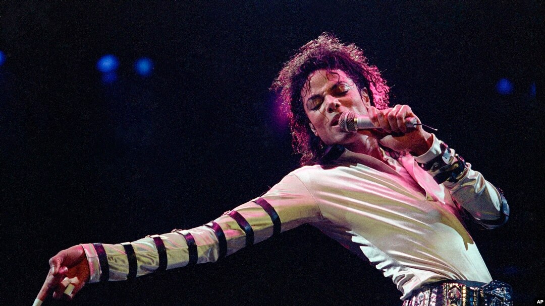 FILE - Michael Jackson leans, points and sings, dances and struts during the opening performance of his 13-city U.S. tour, in Kansas City, Mo. 