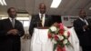 Malawi’s presidential aspirant in the May 20 tripartite elections and head of Malawi's United Democratic Front (UDF) party Atupele Muluzi (C) speaks next to his running mate Godfrey Chapola (L) and a Malawi Electoral Commission official (R) to present his nomination papers to the Commission, Feb. 12, 2014, Blantyre.