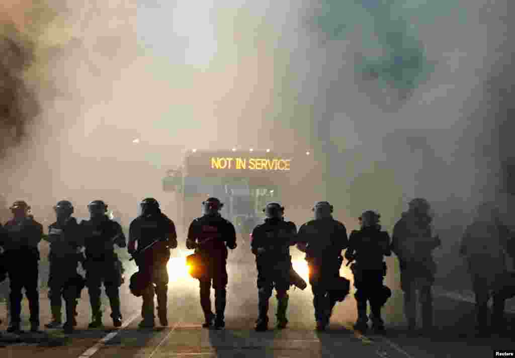 Police officers wearing riot gear block a road during protests after police fatally shot Keith Lamont Scott in the parking lot of an apartment complex in Charlotte, North Carolina, Sept. 20, 2016.