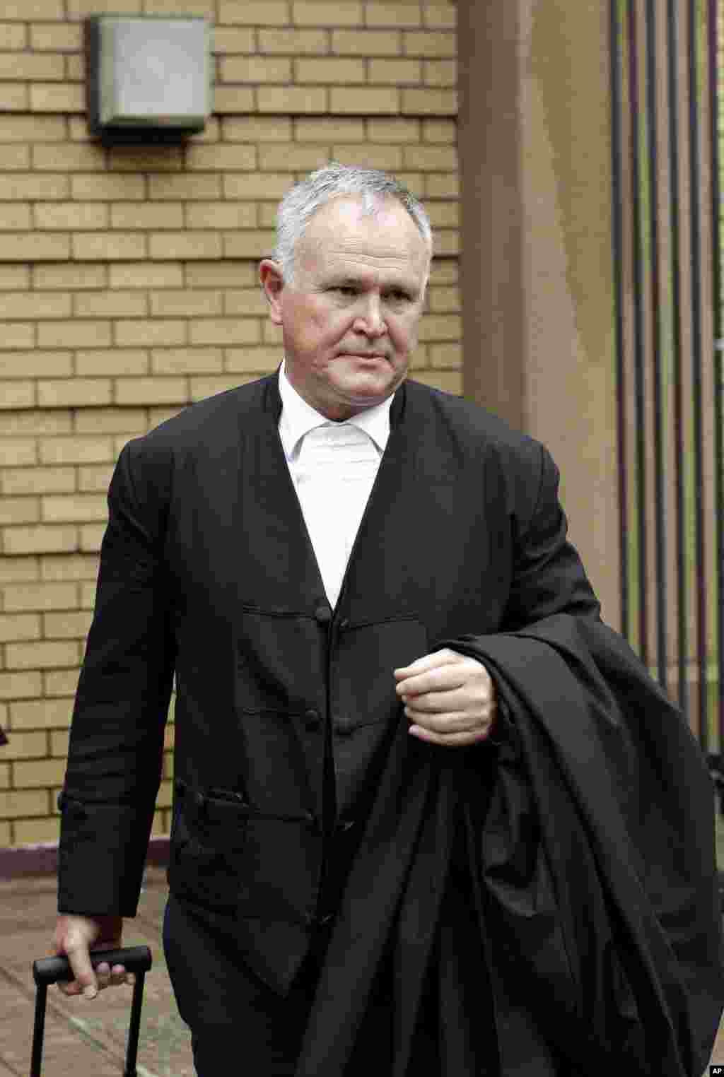 Oscar Pistorius's lawyer, Barry Roux, arrives at the high court in Pretoria. The State Prosecutor Gerrie Nel presented arguments in the case against Pistorius, who was acquitted of murder for killing girlfriend Reeva Steenkamp, South Africa, Dec. 9, 2014. 