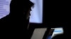 FILE - A man takes part in a hacking contest in Las Vegas, Nevada, July 29, 2017. The FBI and private cybersecurity firms have started teaming up to take down computer hackers.