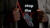 FILE - A man's T-shirt reads "Stop the Cut," referring to female genital mutilation, during a social event advocating against such practices at a school for girls in Imbirikani, Kenya, April 21, 2016.