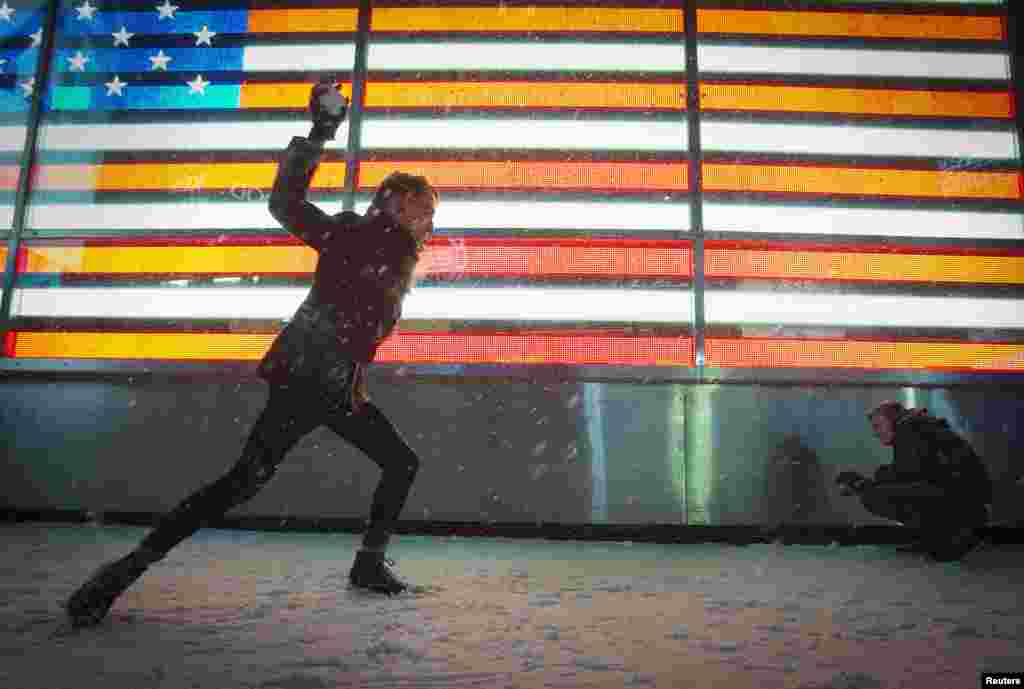 As pessoas brincam com a neve na famosa Times Square em Nova Iorque, Jan. 3, 2014. 
